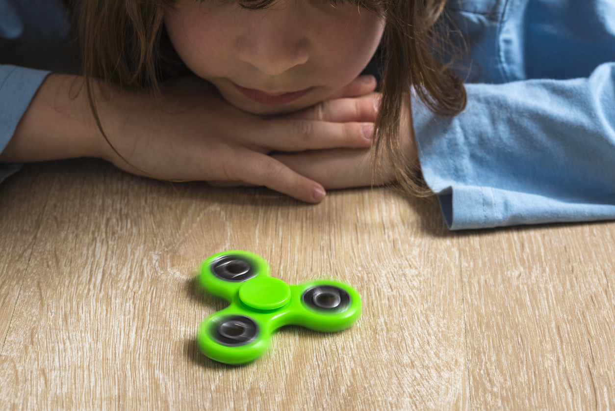 Child playing with fidget spinner