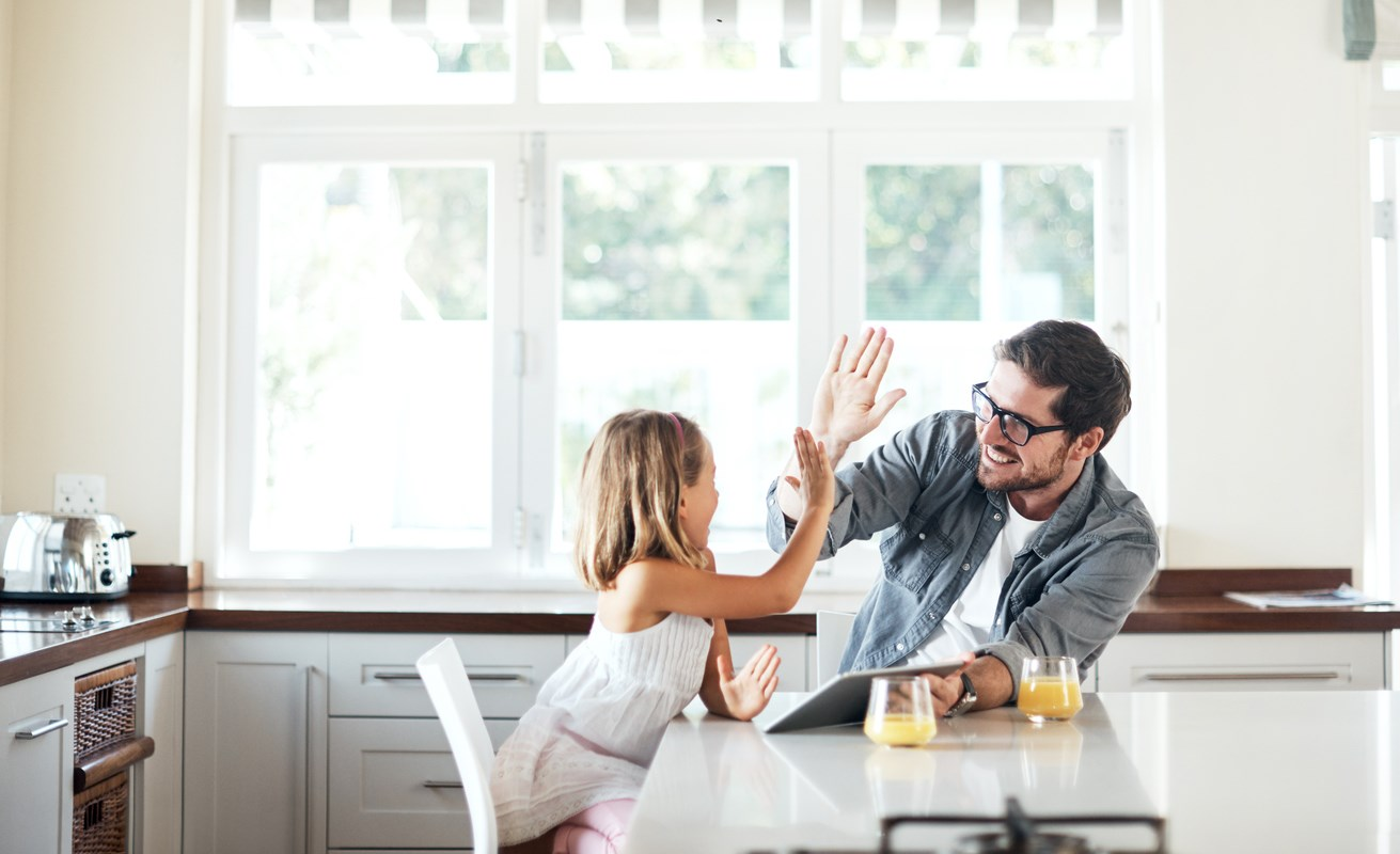 Father and daughter talking in kitchen