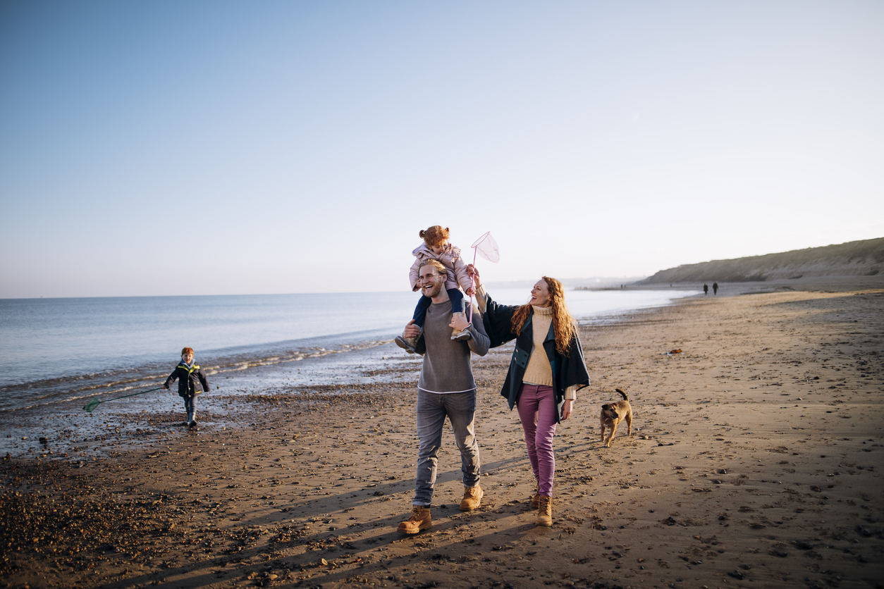 A family walking along the beach.